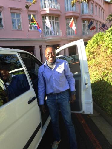 a man is getting out of a white van at DysArt Boutique Hotel - Solar Power in Cape Town
