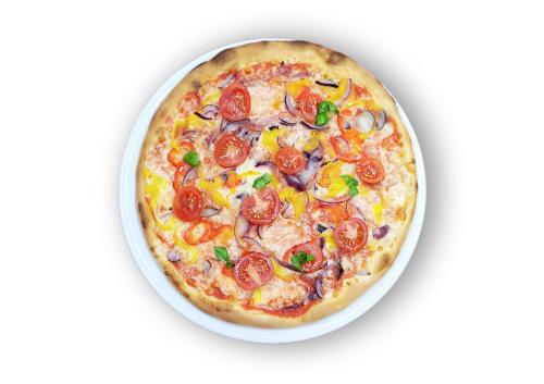 a pizza in a white dish on a white background at Hotel Karinhall in Trento