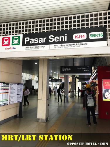 a sign in a airport with people walking through a mall at Lavana Hotel, Chinatown in Kuala Lumpur