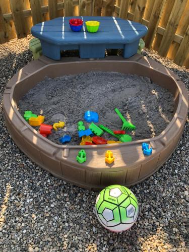 a childs toy sandbox with a soccer ball at Ankerplatz Güby in Güby