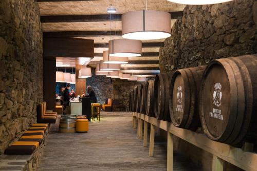 a row of wine barrels in a wine cellar at Vila Gale Douro Vineyards in Armamar