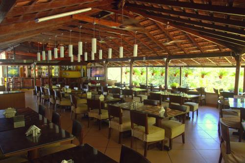 a dining room with tables and chairs in a restaurant at Colonia Santa Maria in Baga