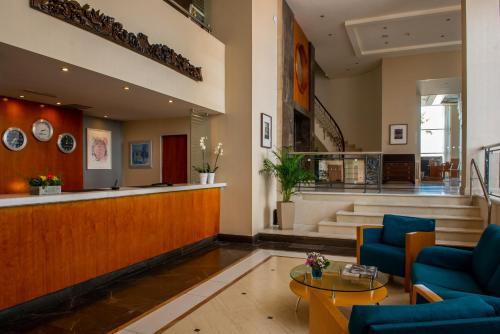 a lobby with blue chairs and a waiting room at Chios Chandris in Chios