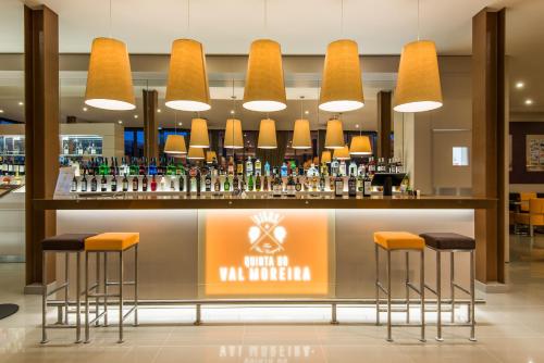 a bar in a hotel lobby with stools at Vila Gale Douro Vineyards in Armamar