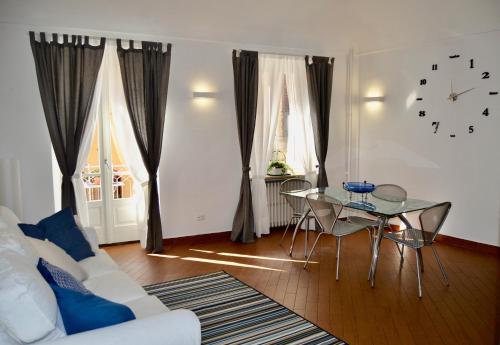 een woonkamer met een witte bank en een glazen tafel bij La mia casa in Biella