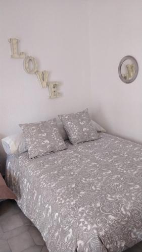 a bed with two pillows on it in a bedroom at Beach Studio Benalmádena in Benalmádena