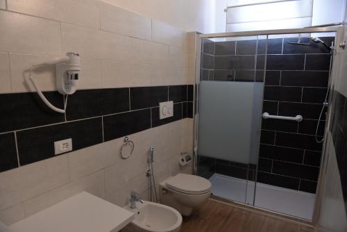 a bathroom with a toilet and a shower at Residence Del Tellaro in Noto Marina