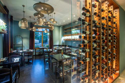 a dining room with a wall of wine bottles at The Rothschild Hotel - Tel Aviv's Finest in Tel Aviv