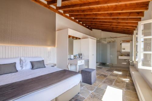 a bedroom with a large bed and a bathroom at Limassol Old Town Mansion in Limassol
