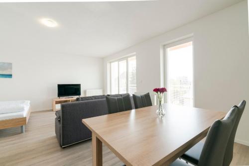a living room with a table and a couch at Apartmány Noviny in Trenčín