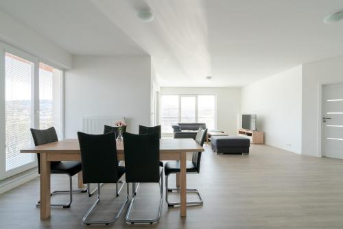 a dining room with a table and chairs at Apartmány Noviny in Trenčín