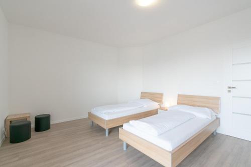 a room with two beds in a room at Apartmány Noviny in Trenčín
