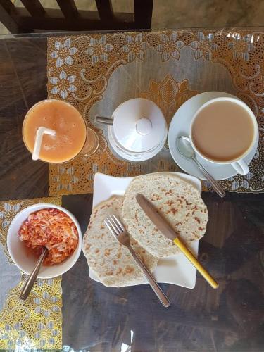 a table with plates of food and a cup of coffee at skyresort in Tangalle