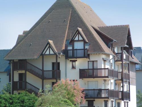 a large house with balconies on the side of it at Lagrange Vacances Les Résidences in Cabourg