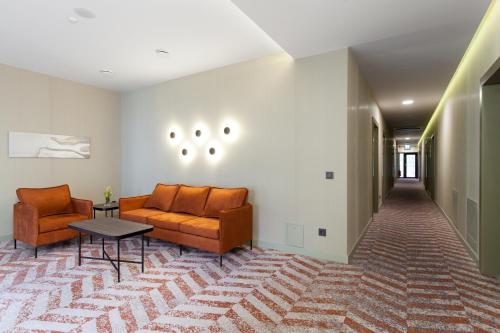 a living room with a couch and chairs and a table at Kaunas in Kaunas