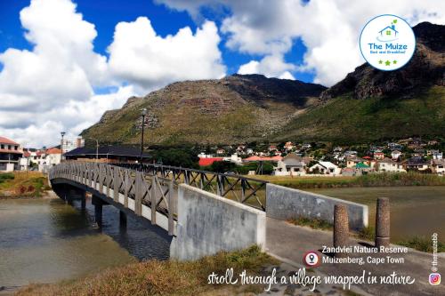 a train on a bridge over a river at The Muize in Muizenberg
