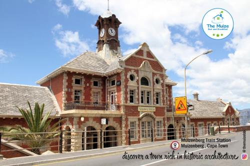 a building with a clock tower on top of it at The Muize in Muizenberg