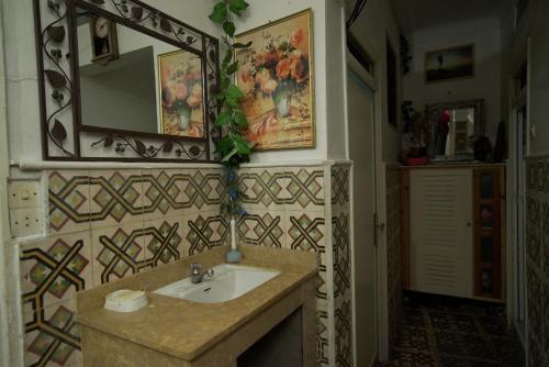 a bathroom with a sink and a mirror at White And Blue in Essaouira