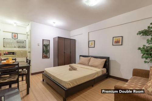 a bedroom with a bed with a teddy bear on it at Pension Inn Marilao in Lias