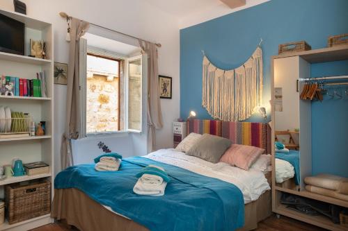 a bedroom with a bed with two towels on it at Guest House Blue Wave in Dubrovnik