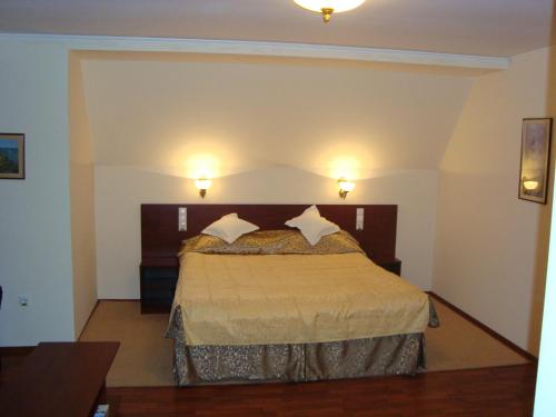 a bedroom with a bed with two pillows on it at Casa Maria Arges in Piteşti