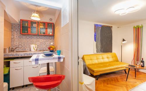 a kitchen with a yellow chair and a table in a room at The Art Republic, Old Town in Dubrovnik