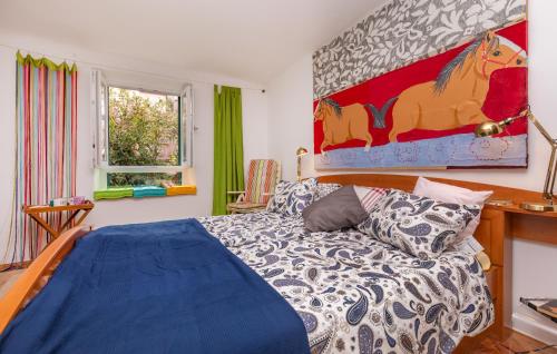 a bedroom with a bed and a painting on the wall at The Art Republic, Old Town in Dubrovnik