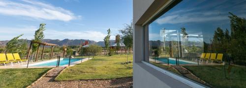 a view of a swimming pool from a window at Cabañas EcoNature in Valle Grande