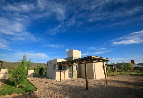 a small white building with a roof at Cabañas EcoNature in Valle Grande