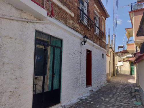 an alley with a door on the side of a building at Private room historic center Elbasan in Elbasan