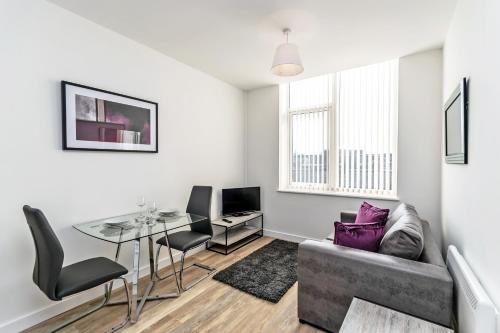 a living room with a couch and a table at City Suites by Guestz in Chester