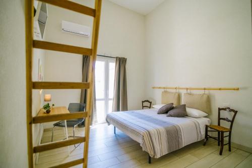 a bedroom with a bunk bed and a ladder at Ciatu Miu in Noto