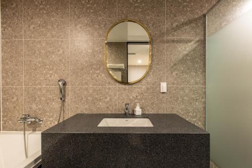 a bathroom with a sink and a mirror at Brown Dot Gijang Yeonhwari in Busan