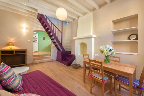 a living room with a table and a purple staircase at Colourful Home, Medieval Town Rhodes in Rhodes Town