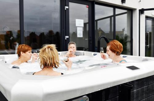 a group of people sitting in a bath tub at Siesta in Grzybowo