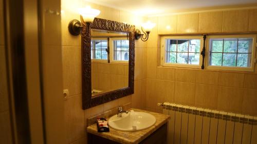 a bathroom with a sink and a mirror at Complex La Tunuri - Vila Economat in Sinaia