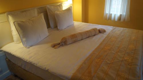 a bed in a room with a bedspread and pillows at Complex La Tunuri - Vila Economat in Sinaia