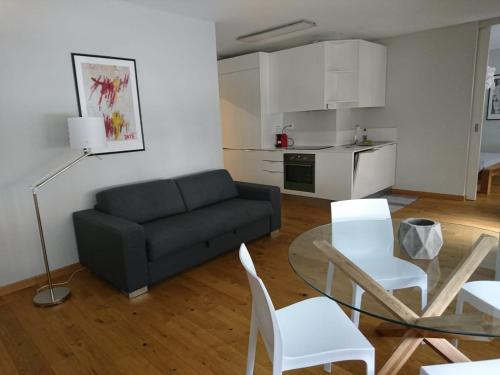 a living room with a couch and a table and chairs at Appartamento Fidanza in Brissago