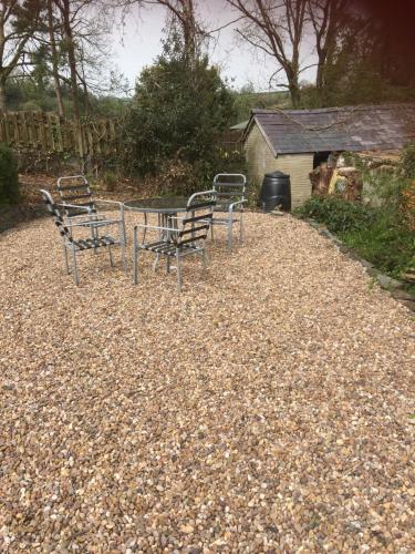 a group of chairs and a table in a yard at Heddfan in Carmarthen
