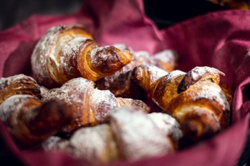 a bunch of pastries in a red bowl at Michelangelo Grand Hotel in Prague