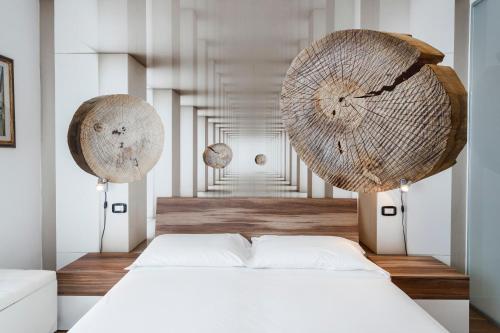 a bedroom with a white bed and a hallway at Hotel Sole Holiday in Arco