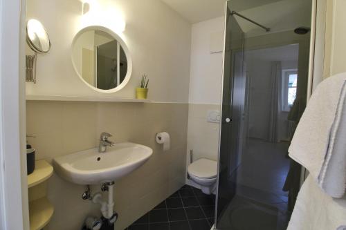 a bathroom with a sink and a shower and a toilet at Maria von Buol - Wohnen in Kaltern in Caldaro
