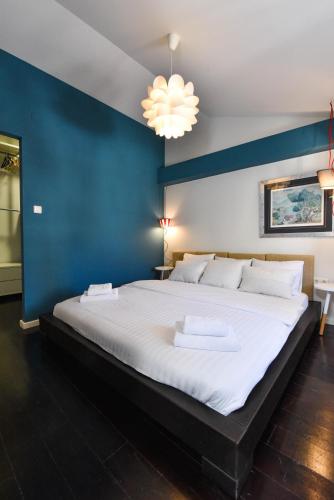 a large bed in a room with a blue wall at Rory Apartments in Zadar