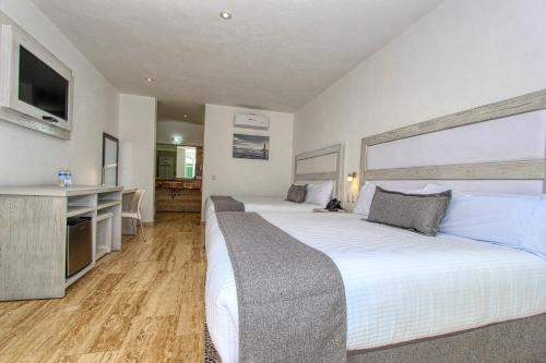 Postel nebo postele na pokoji v ubytování Hotel Splash Inn