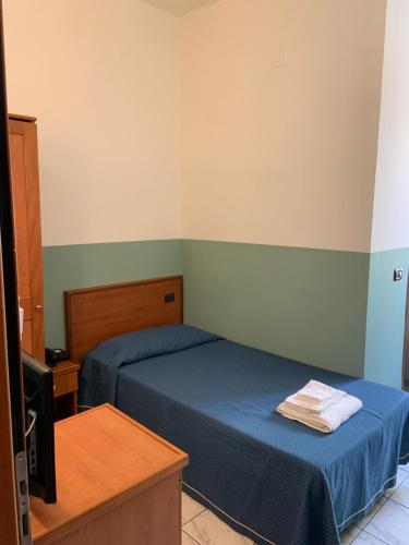 a small bedroom with two beds and a tv at Hotel Lungomare in Reggio Calabria