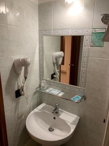 a bathroom with a sink and a mirror at Hotel Lungomare in Reggio Calabria