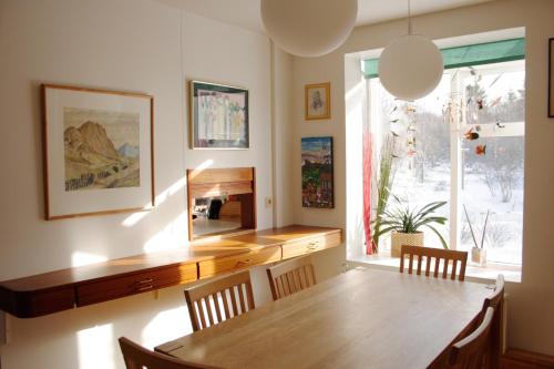 een eetkamer met een houten tafel en een raam bij Úlfarsfellsvegur 20, 113 Rvk Birkihlid in Reykjavík