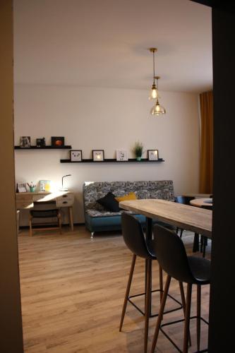 a living room with a table and a couch at Simple & Elegant Apartment in Liepāja