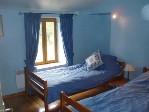 a bedroom with two beds and a window at Les Pics Blancs in La Courtète