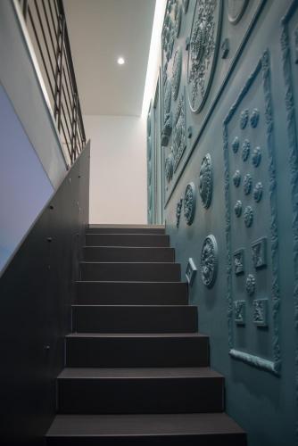 a staircase in a building with plates on the wall at Il Cavaliere Bed and Breakfast in Caserta